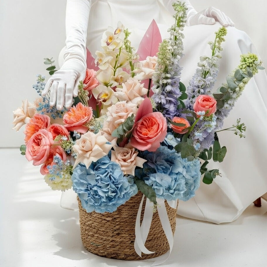 Bouquet of flowers held by a person wearing white gloves on a plain background