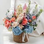 Bouquet of flowers held by a person wearing white gloves on a plain background